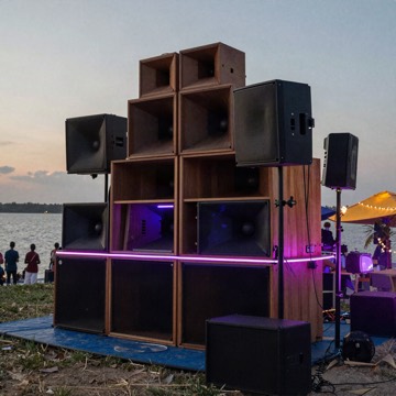 Sound system speakers at a lakeside party at dusk