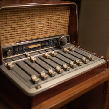 Radio studio desk with a microphone and mixing faders