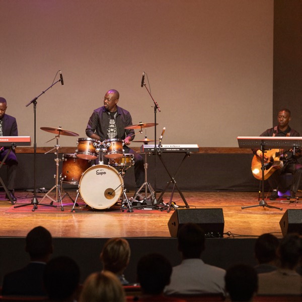 Gospel concert stage with drums and keyboard under warm lights