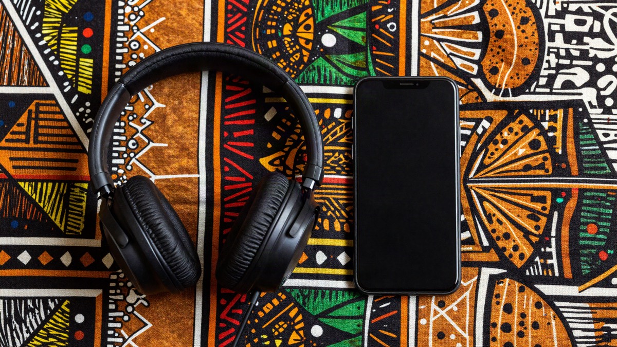 Headphones and a phone on colourful African wax print fabric