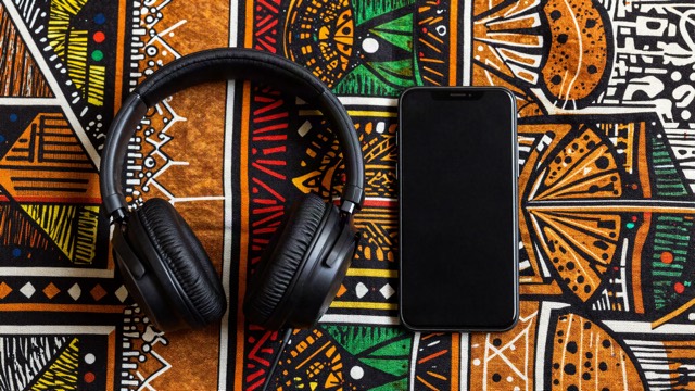 Headphones and a phone on colourful African wax print fabric