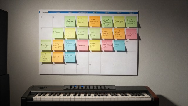 Calendar covered in sticky notes planning a release